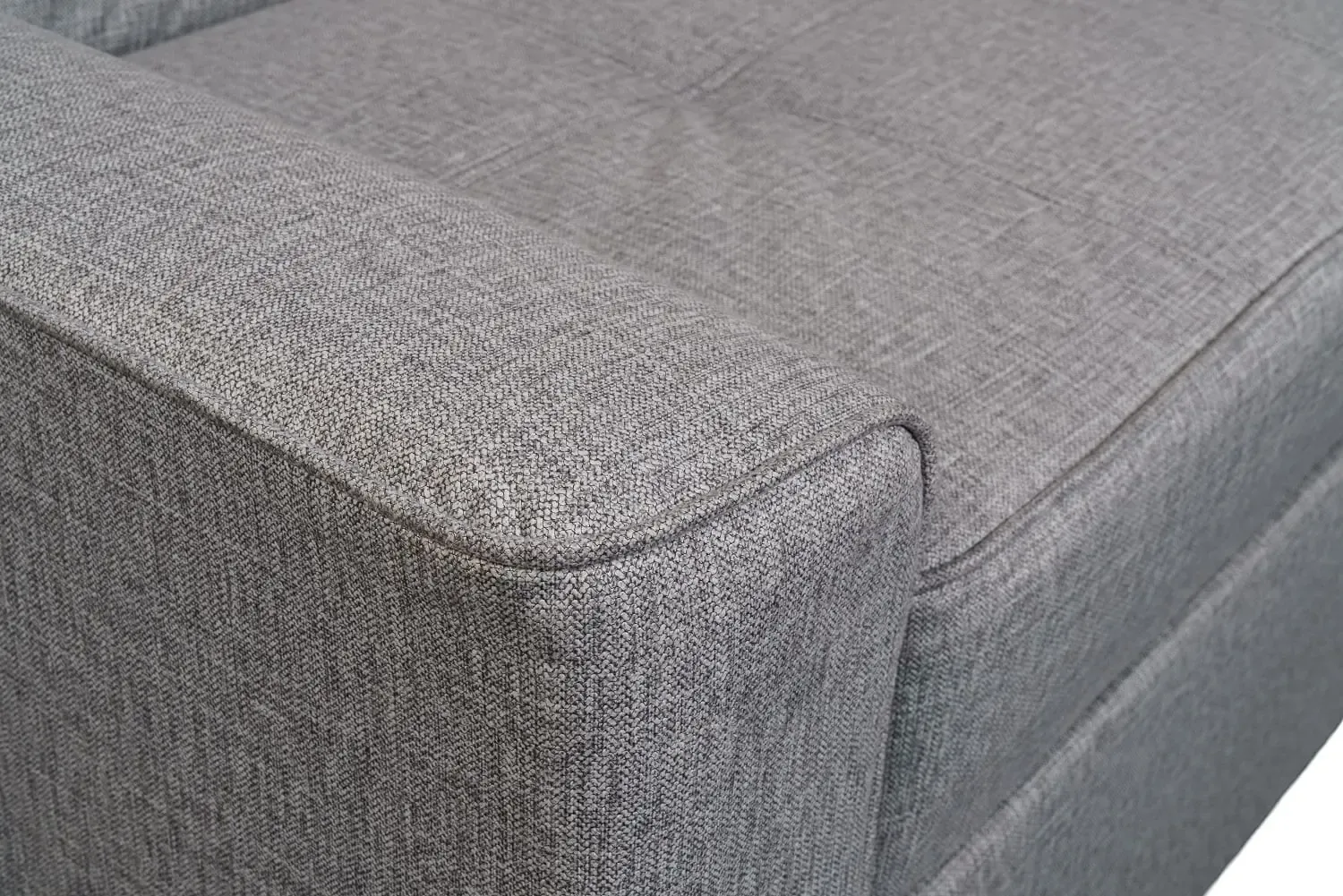Close-up of the corner of a SIXTREND Flex sofa showing tightly-woven grey upholstery fabric and crisp seam piping.