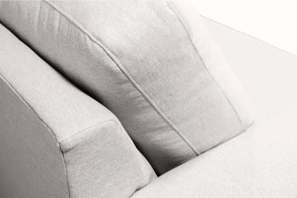 Close-up of plush back and seat cushions on a SIXTREND sofa in light grey textured upholstery, showing seam detail.