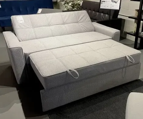 A SIXTREND Flex sofa bed on display in the Toronto showroom, with its trundle fully extended into the sleeping configuration.