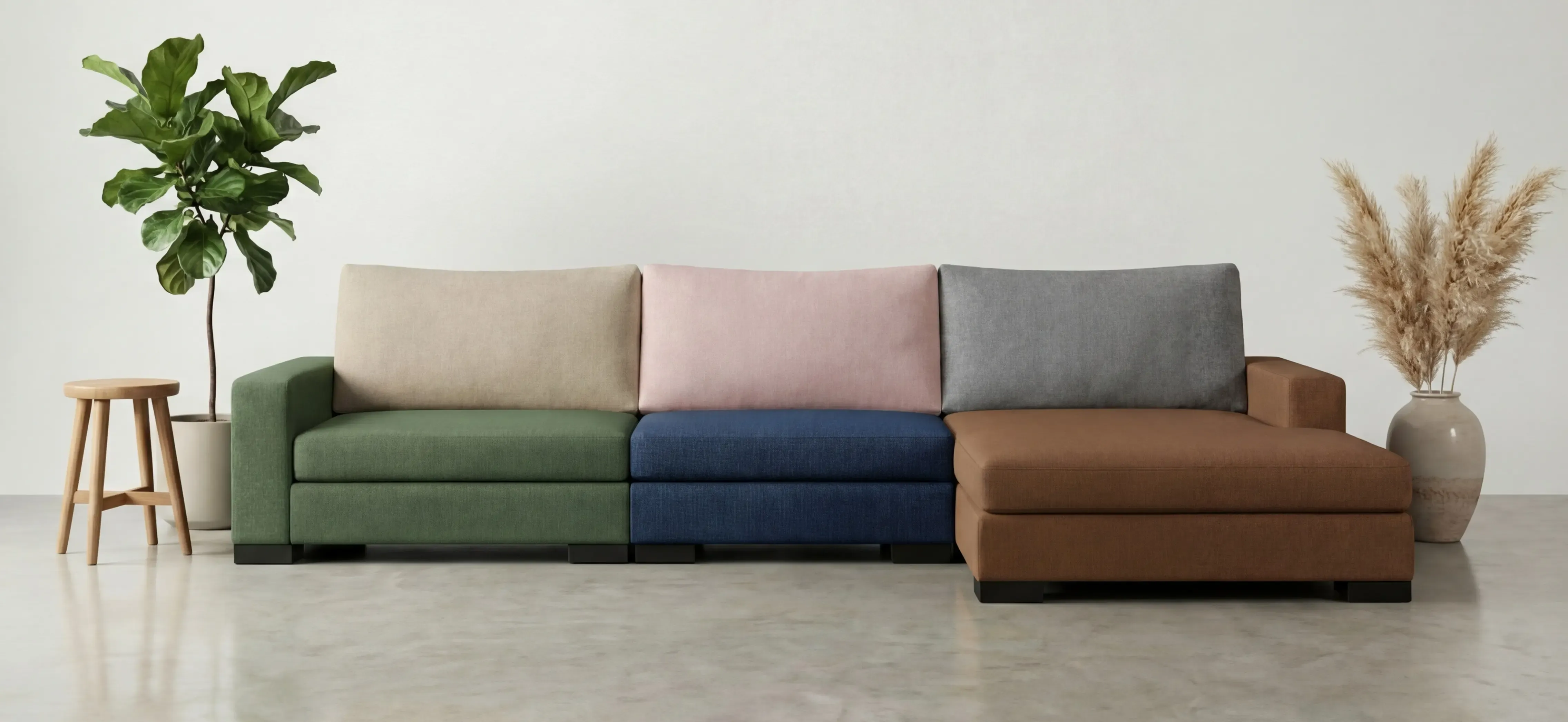 Modular sectional sofa configured with green, blush, navy, grey, and tan upholstery