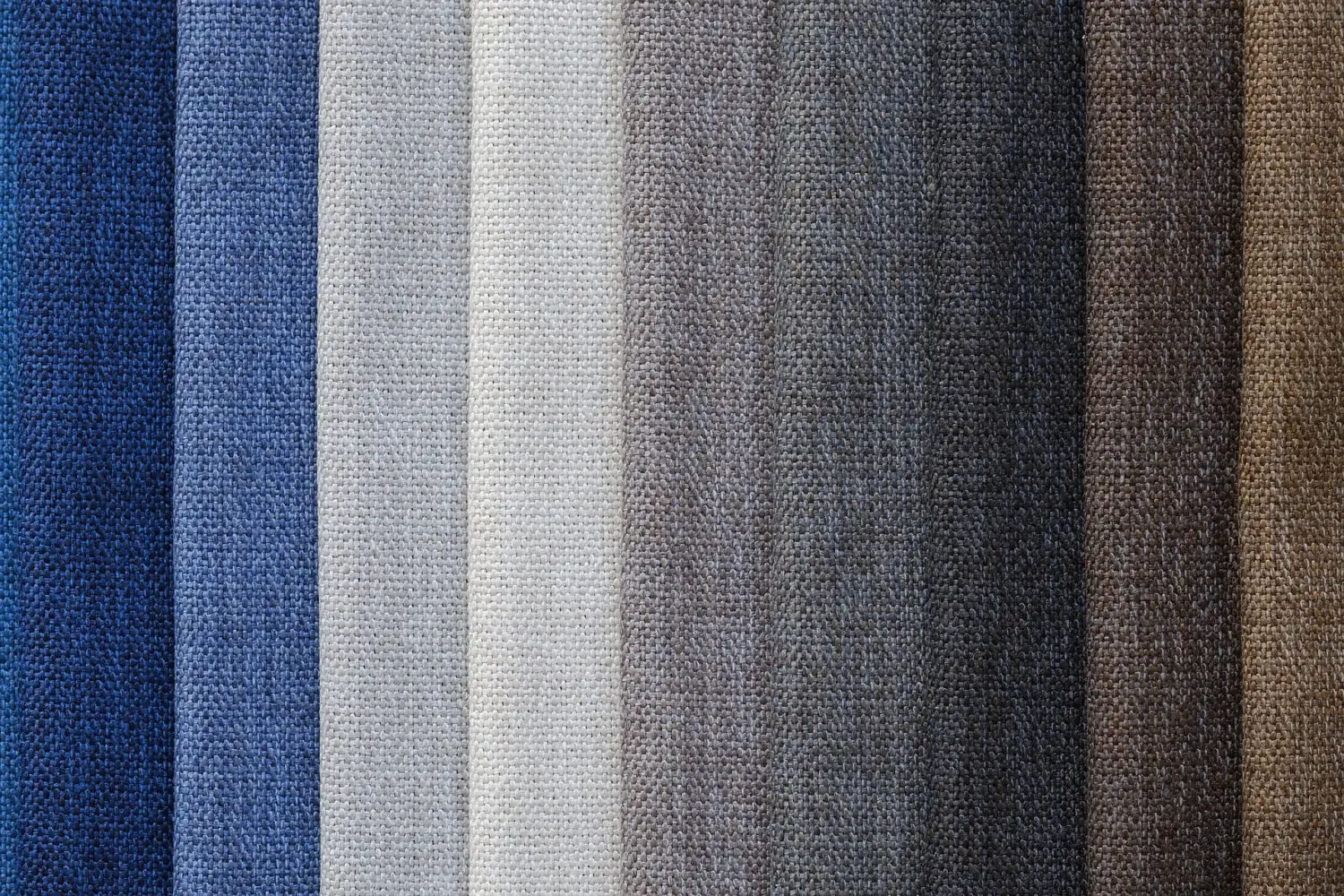 Upholstery fabric swatches available in blues, neutrals, and browns for design consultations