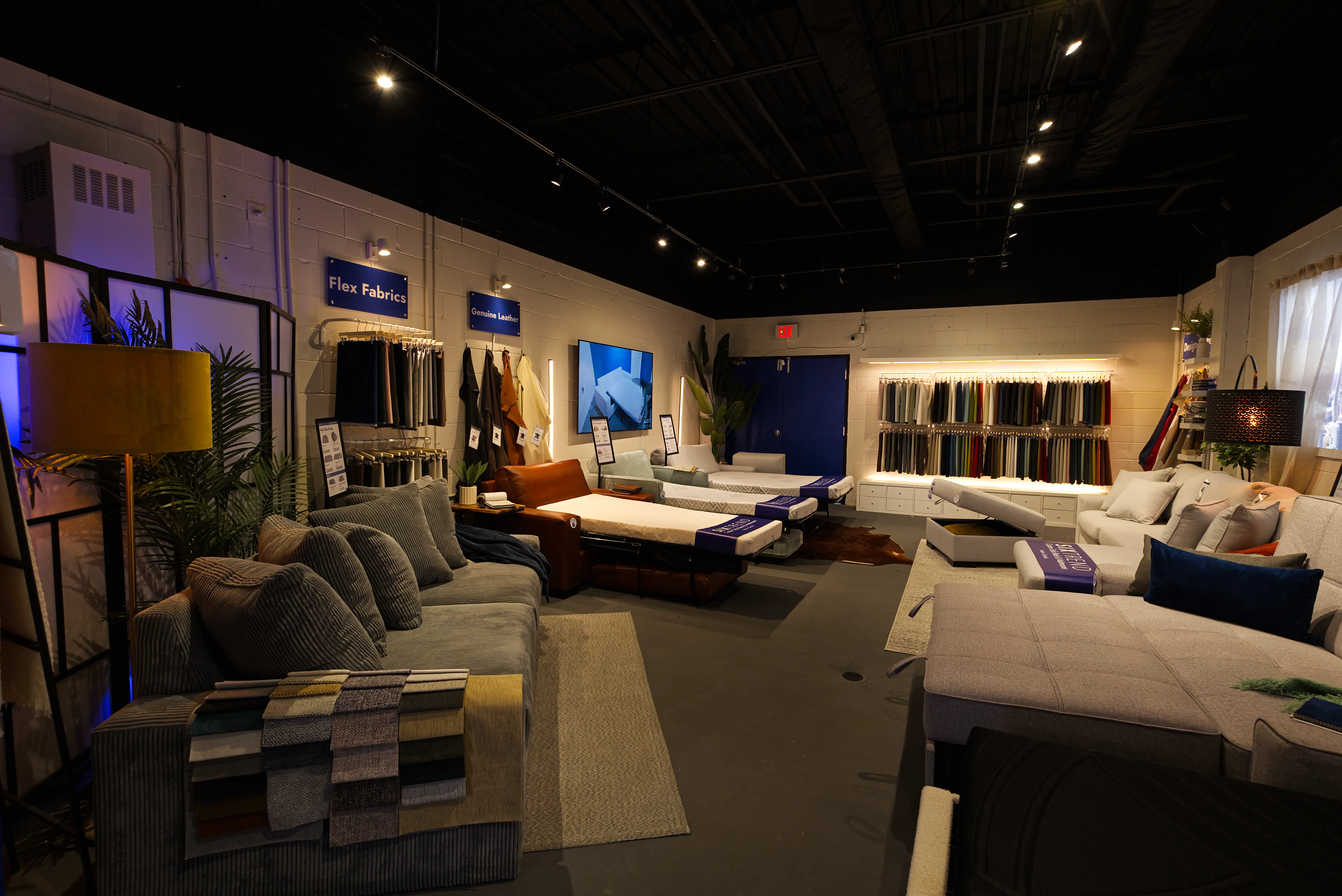 SIXTREND showroom interior — sofas, fabric swatches, and lighting displays