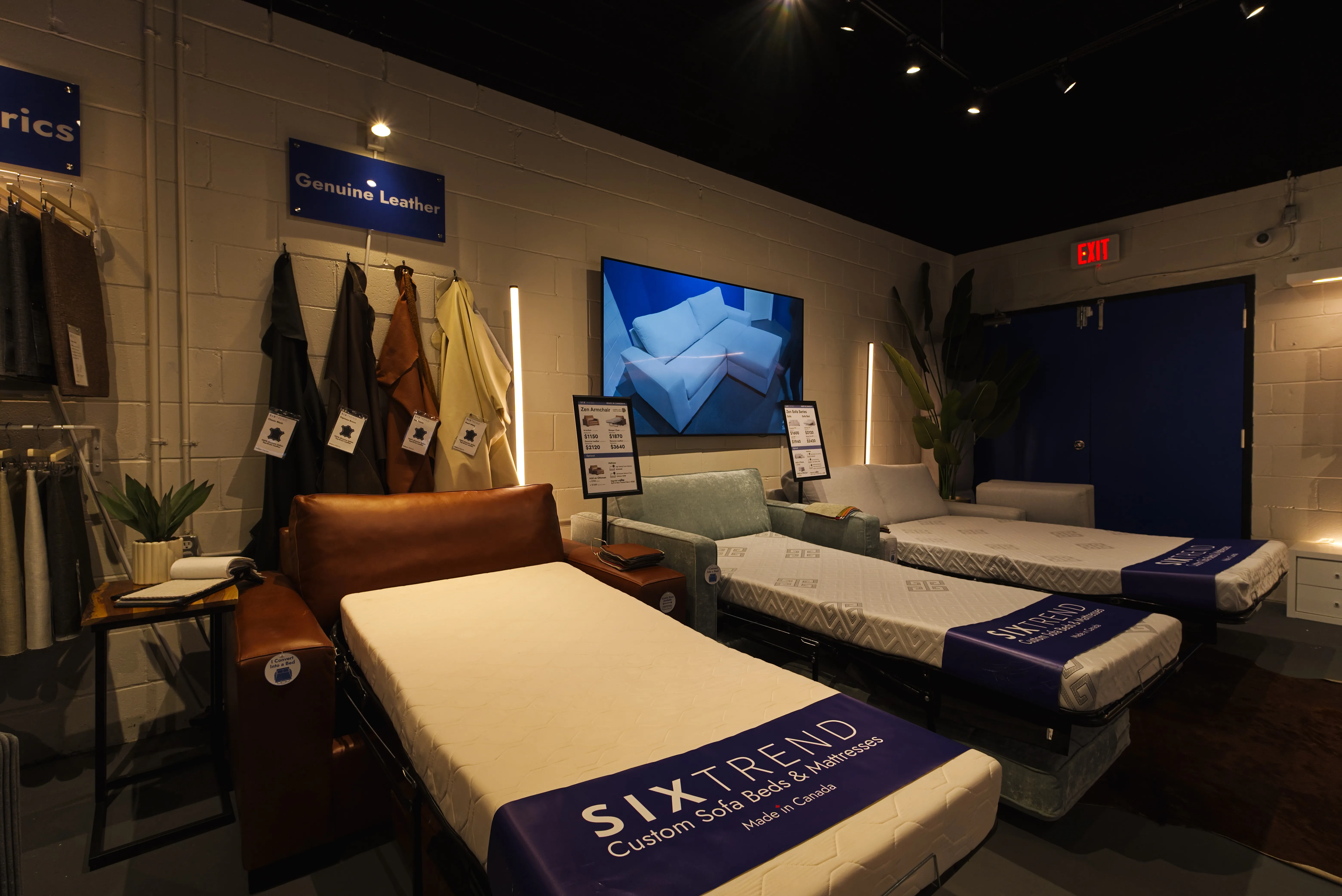 SIXTREND showroom display of custom sofa beds with branded mattress wraps reading 'Custom Sofa Beds & Mattresses Made in Canada'