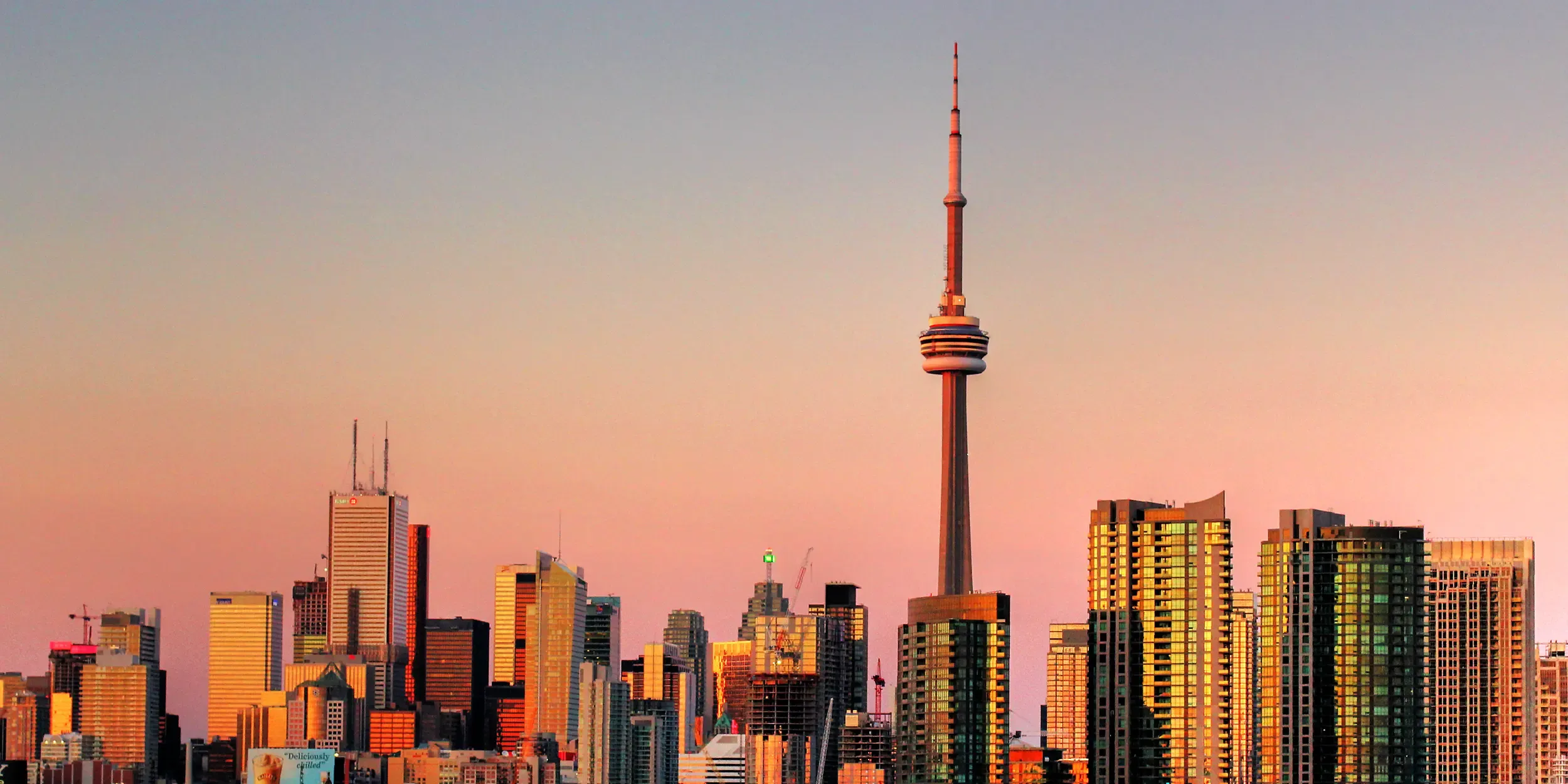Toronto skyline at sunset with the CN Tower and downtown high-rises